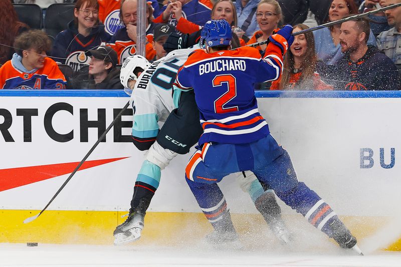 Jan 27, 2025; Edmonton, Alberta, CAN; Seattle Kraken forward Andre Burakovsky (95) and Edmonton Oilers defensemen Evan Bouchard (2) battle along the boards for a loose puck  during the second period at Rogers Place. Mandatory Credit: Perry Nelson-Imagn Images