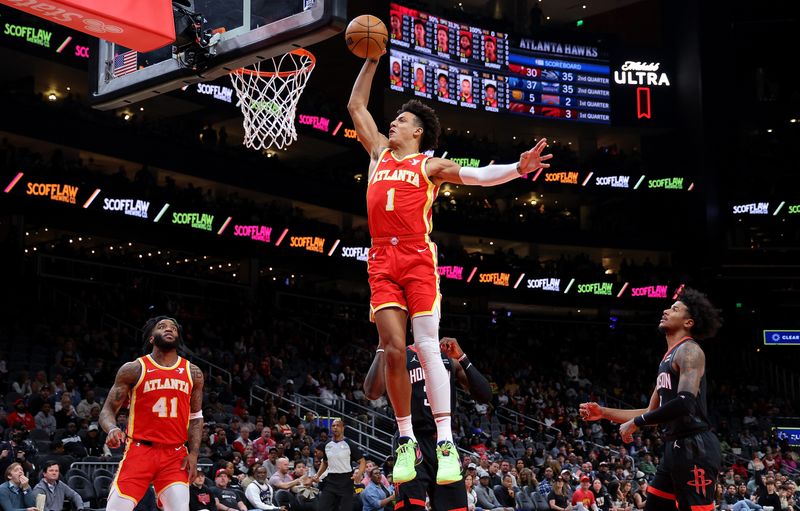 ATLANTA, GEORGIA - FEBRUARY 10:  Jalen Johnson #1 of the Atlanta Hawks dunks against Jeff Green #32 and Jalen Green #4 of the Houston Rockets during the first quarter at State Farm Arena on February 10, 2024 in Atlanta, Georgia.  NOTE TO USER: User expressly acknowledges and agrees that, by downloading and/or using this photograph, user is consenting to the terms and conditions of the Getty Images License Agreement.  (Photo by Kevin C. Cox/Getty Images)