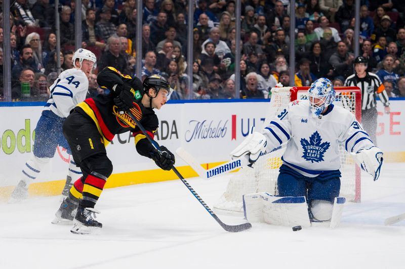 Jan 20, 2024; Vancouver, British Columbia, CAN; Toronto Maple Leafs goalie Martin Jones (31) makes a save on Vancouver Canucks forward Teddy Blueger (53) in the first period at Rogers Arena. Mandatory Credit: Bob Frid-USA TODAY Sports