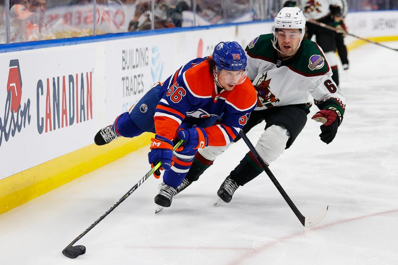 Mar 22, 2023; Edmonton, Alberta, CAN; Edmonton Oilers forward Kailer Yamamoto (56) and Arizona Coyotes forward Matias Maccelli (63) battle for a loose puck during the third period at Rogers Place. Mandatory Credit: Perry Nelson-USA TODAY Sports