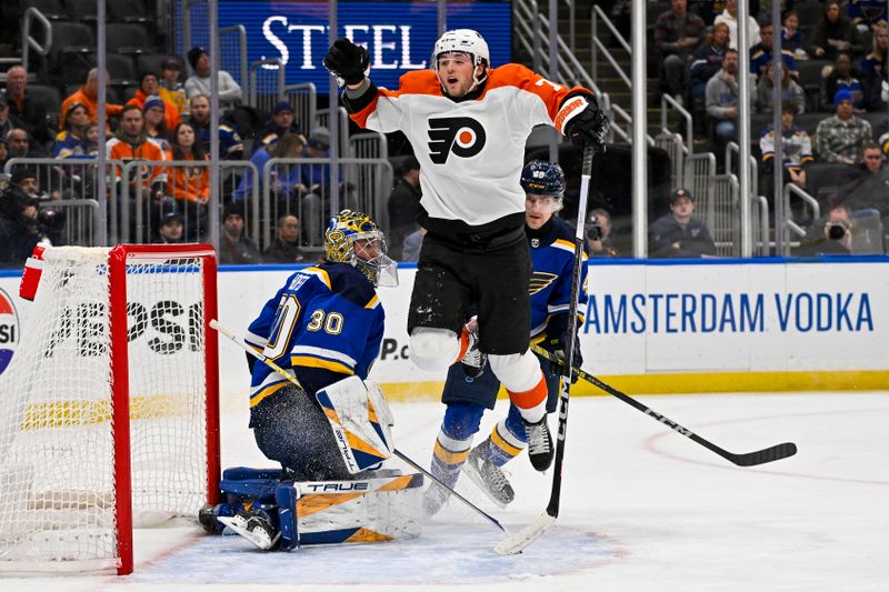 Jan 15, 2024; St. Louis, Missouri, USA;  Philadelphia Flyers right wing Tyson Foerster (71) leaps past St. Louis Blues goaltender Joel Hofer (30) during the first period at Enterprise Center. Mandatory Credit: Jeff Curry-USA TODAY Sports