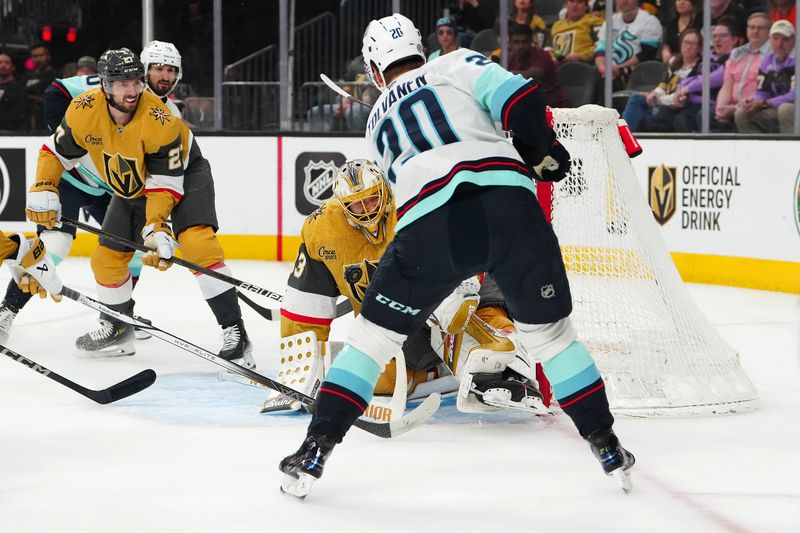 Apr 10, 2025; Las Vegas, Nevada, USA; Vegas Golden Knights goaltender Adin Hill (33) makes a save against Seattle Kraken right wing Eeli Tolvanen (20) during the first period at T-Mobile Arena. Mandatory Credit: Stephen R. Sylvanie-Imagn Images