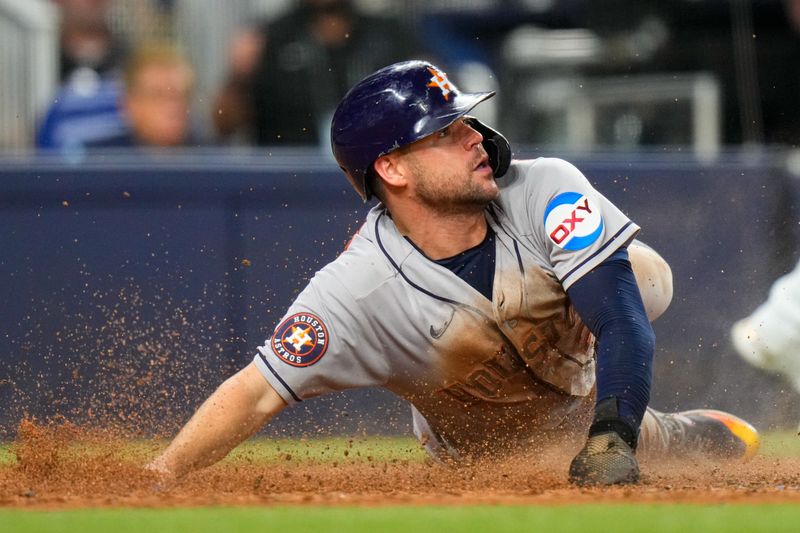 Aug 16, 2023; Miami, Florida, USA; Houston Astros center fielder Chas McCormick (20) slides into home base against the Miami Marlins during the seventh inning at loanDepot Park. Mandatory Credit: Rich Storry-USA TODAY Sports