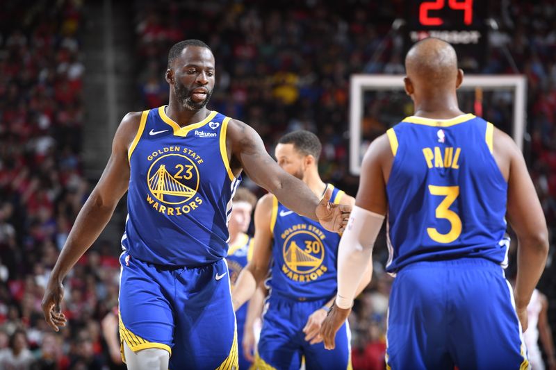 HOUSTON, TX - APRIL 4: Draymond Green #23 of the Golden State Warriors high fives Chris Paul #3 during the game against the Houston Rockets on April 4, 2024 at the Toyota Center in Houston, Texas. NOTE TO USER: User expressly acknowledges and agrees that, by downloading and or using this photograph, User is consenting to the terms and conditions of the Getty Images License Agreement. Mandatory Copyright Notice: Copyright 2024 NBAE (Photo by Logan Riely/NBAE via Getty Images)