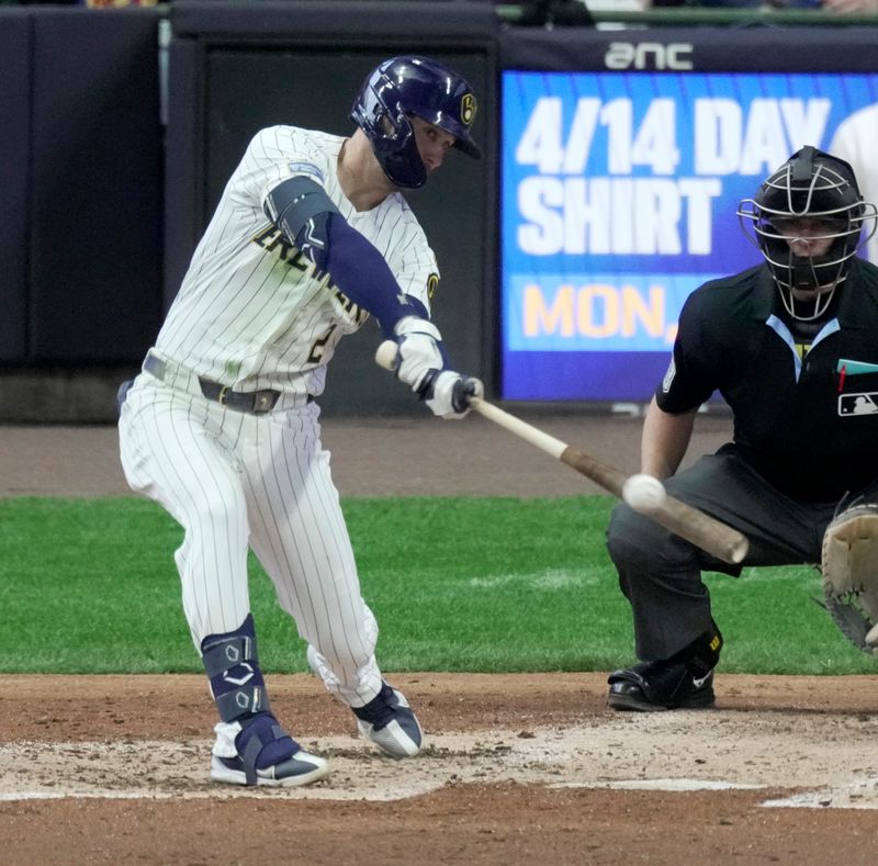 Apr 6, 2025; Milwaukee, Wisconsin, USA; Milwaukee Brewers second base Brice Turang (2) hits a single during the fourth inning of their game against the Cincinnati Reds at American Family Field. Mandatory Credit: Mark Hoffman-USA Today Network via Imagn Images 