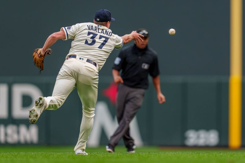 Sep 24, 2023; Minneapolis, Minnesota, USA; Minnesota Twins starting pitcher Louie Varland (37) throws to first to retire Los Angeles Angels second baseman David Fletcher (22) in the seventh inning at Target Field. Mandatory Credit: Matt Blewett-USA TODAY Sports