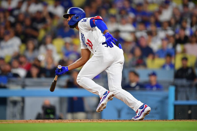 September 1, 2023; Los Angeles, California, USA;  Los Angeles Dodgers designated hitter Amed Rosario (31) hits a single against the Atlanta Braves during the eighth inning at Dodger Stadium. Mandatory Credit: Gary A. Vasquez-USA TODAY Sports