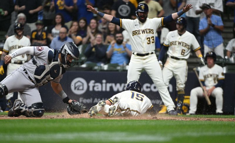 May 23, 2023; Milwaukee, Wisconsin, USA; Milwaukee Brewers Milwaukee Brewers center fielder Tyrone Taylor (15) slides into home safely against the Houston Astros at American Family Field. Mandatory Credit: Michael McLoone-USA TODAY Sports