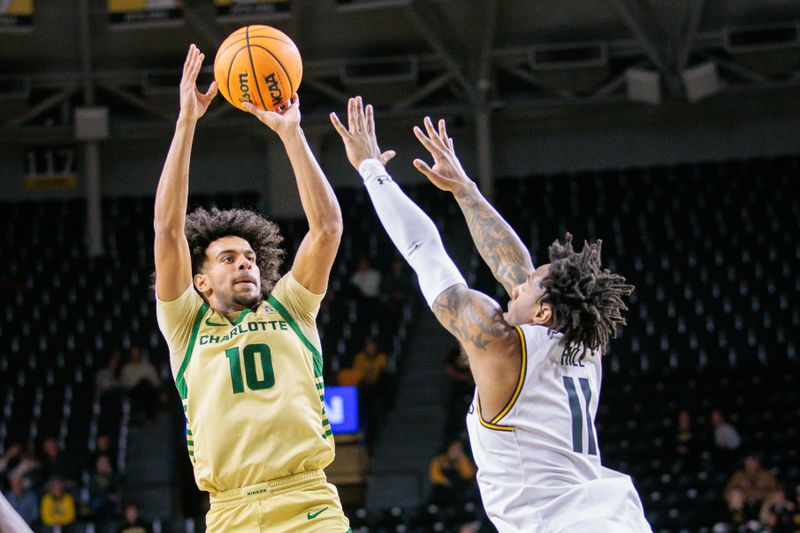 Jan 14, 2025; Wichita, Kansas, USA; Charlotte 49ers guard Nik Graves (10) shoots the ball over Wichita State Shockers guard Justin Hill (11) during the first half at Charles Koch Arena. Mandatory Credit: William Purnell-Imagn Images