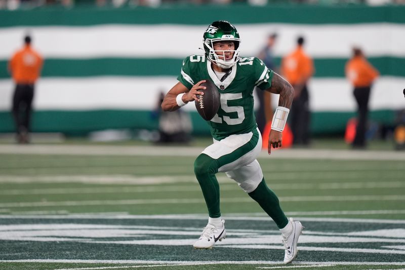 New York Jets quarterback Adrian Martinez scrambles during the first half of a preseason NFL football game against the New York Giants, Saturday, Aug. 24, 2024, in East Rutherford, N.J. (AP Photo/Bryan Woolston)