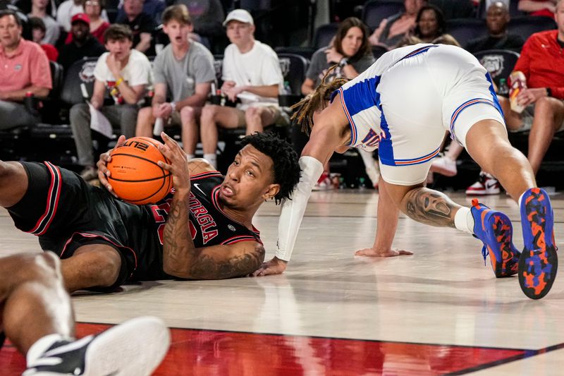 Feb 28, 2023; Athens, Georgia, USA; Georgia Bulldogs center Braelen Bridges (23) controls a loose ball on the floor next to Florida Gators guard Riley Kugel (24) during the second half at Stegeman Coliseum. Mandatory Credit: Dale Zanine-USA TODAY Sports