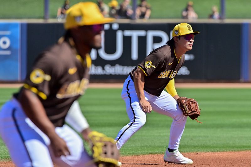 Mar 1, 2024; Peoria, Arizona, USA; San Diego Padres shortstop Ha-Seong Kim (7) and third baseman Eguy Rosario (5) defend in the first inning against the Los Angeles Angels during a spring training game  at Peoria Sports Complex. Mandatory Credit: Matt Kartozian-USA TODAY Sports