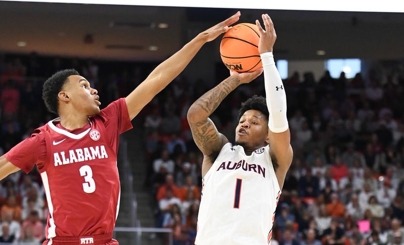 Feb 11, 2023; Auburn, Alabama, USA;  Alabama Crimson Tide guard Rylan Griffen (3) blocks a shot by Auburn Tigers guard Wendell Green Jr. (1) at Neville Arena. Mandatory Credit: Julie Bennett-USA TODAY Sports

