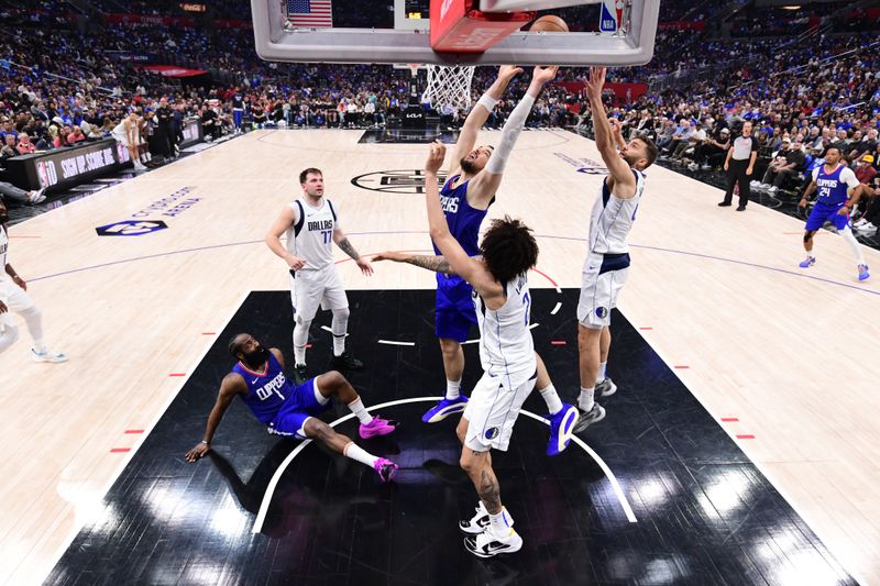 LOS ANGELES, CA - APRIL 21:  Ivica Zubac #40 of the LA Clippers battles for a rebound against the Dallas Mavericks during Round 1 Game 1 of the 2024 NBA Playoffs on April 21, 2024 at Crypto.Com Arena in Los Angeles, California. NOTE TO USER: User expressly acknowledges and agrees that, by downloading and/or using this Photograph, user is consenting to the terms and conditions of the Getty Images License Agreement. Mandatory Copyright Notice: Copyright 2024 NBAE (Photo by Adam Pantozzi/NBAE via Getty Images)