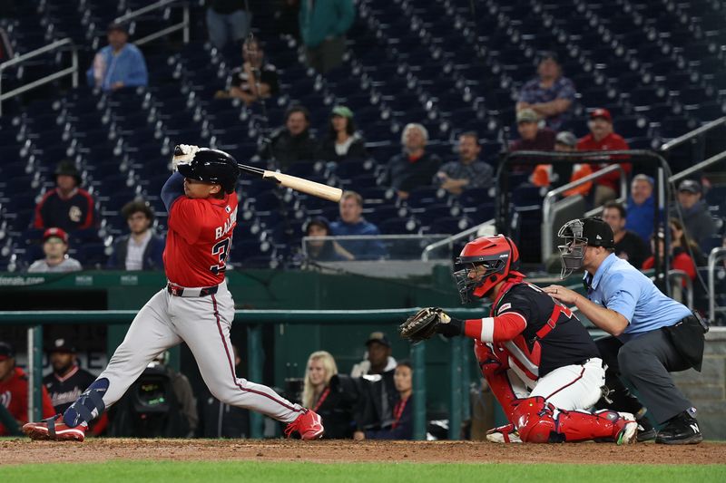 Sep 16, 2025; Washington, District of Columbia, USA; Atlanta Braves catcher Drake Baldwin (30) hits a go ahead RBI double against the Washington Nationals during the tenth inning at Nationals Park. Mandatory Credit: Geoff Burke-Imagn Images
