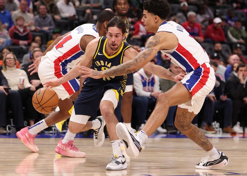 DETROIT, MICHIGAN - DECEMBER 11: T.J. McConnell #9 of the Indiana Pacers drives between Killian Hayes #7 and Alec Burks #14 of the Detroit Pistons during the second half at Little Caesars Arena on December 11, 2023 in Detroit, Michigan. Indiana won the game 131-123. NOTE TO USER: User expressly acknowledges and agrees that, by downloading and or using this photograph, User is consenting to the terms and conditions of the Getty Images License Agreement. (Photo by Gregory Shamus/Getty Images)