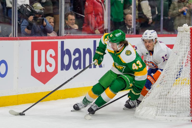 Jan 10, 2026; Saint Paul, Minnesota, USA; Minnesota Wild defenseman Quinn Hughes (43) and New York Islanders center Mathew Barzal (13) plays the puck behind the net in the overtime period at Grand Casino Arena. Mandatory Credit: Matt Blewett-Imagn Images