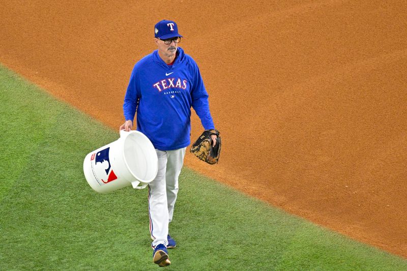 Oct 28, 2023; Arlington, Texas, USA; Texas Rangers pitching coach Mike Maddox walks on to the field during batting practice before the game between the Texas Rangers and the Arizona Diamondbacks in game two of the 2023 World Series at Globe Life Field. Mandatory Credit: Jerome Miron-USA TODAY Sports