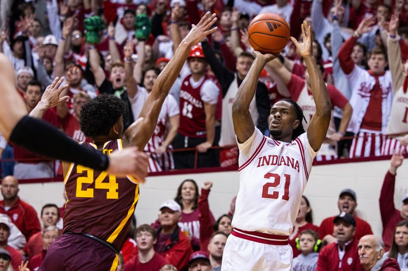 Jan 12, 2024; Bloomington, Indiana, USA; Indiana Hoosiers forward Mackenzie Mgbako (21) shoots the ball while Minnesota Golden Gophers guard Cam Christie (24) defends  in the first half at Simon Skjodt Assembly Hall. Mandatory Credit: Trevor Ruszkowski-USA TODAY Sports