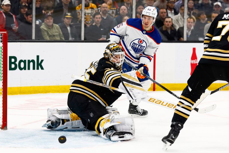 Mar 5, 2024; Boston, Massachusetts, USA; Boston Bruins goaltender Linus Ullmark (35) makes a blocker save as Edmonton Oilers left wing Dylan Holloway (55) looks for a rebound during the first period at TD Garden. Mandatory Credit: Winslow Townson-USA TODAY Sports