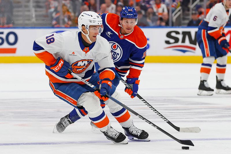 Nov 12, 2024; Edmonton, Alberta, CAN;  New York Islanders forward Pierre Engvall (18) looks to make a pass in front of Edmonton Oilers forward Jeff Skinner (53) during the second periodat Rogers Place. Mandatory Credit: Perry Nelson-Imagn Images