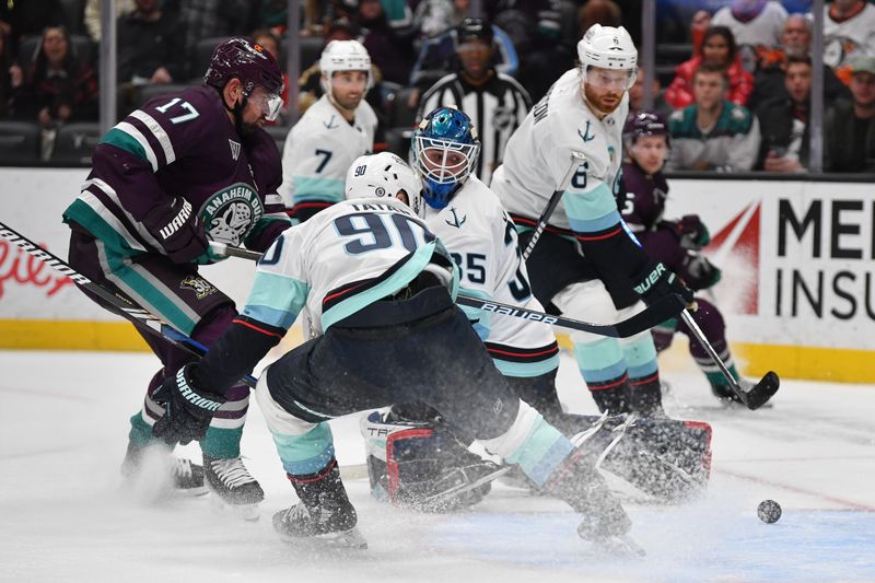 Dec 23, 2023; Anaheim, California, USA; Seattle Kraken left wing Tomas Tatar (90) and defenseman Adam Larsson (6) help goaltender Joey Daccord (35) defend the goal against Anaheim Ducks left wing Alex Killorn (17) during the second period at Honda Center. Mandatory Credit: Gary A. Vasquez-USA TODAY Sports