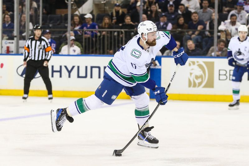 Jan 8, 2024; New York, New York, USA;  Vancouver Canucks defenseman Filip Hronek (17) attempts a shot on goal in the second period against the New York Rangers at Madison Square Garden. Mandatory Credit: Wendell Cruz-USA TODAY Sports