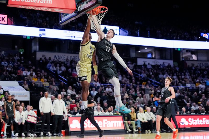 Jan 3, 2026; Winston-Salem, North Carolina, USA;  Wake Forest Demon Deacons guard Myles Colvin (6) with a slam dunk defended by Virginia Tech Hokies guard Neoklis Avdalas (17) during the first half at Lawrence Joel Veterans Memorial Coliseum. Mandatory Credit: Jim Dedmon-Imagn Images
