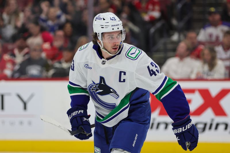 Oct 17, 2024; Sunrise, Florida, USA; Vancouver Canucks defenseman Quinn Hughes (43) looks on after scoring against the Florida Panthers during the second period at Amerant Bank Arena. Mandatory Credit: Sam Navarro-Imagn Images