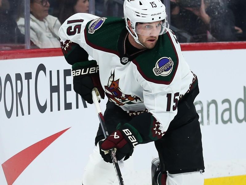 Nov 18, 2023; Winnipeg, Manitoba, CAN;  Arizona Coyotes forward Alexander Kerfoot (15) looks to make a pass against the Winnipeg Jets during the first period at Canada Life Centre. Mandatory Credit: Terrence Lee-USA TODAY Sports