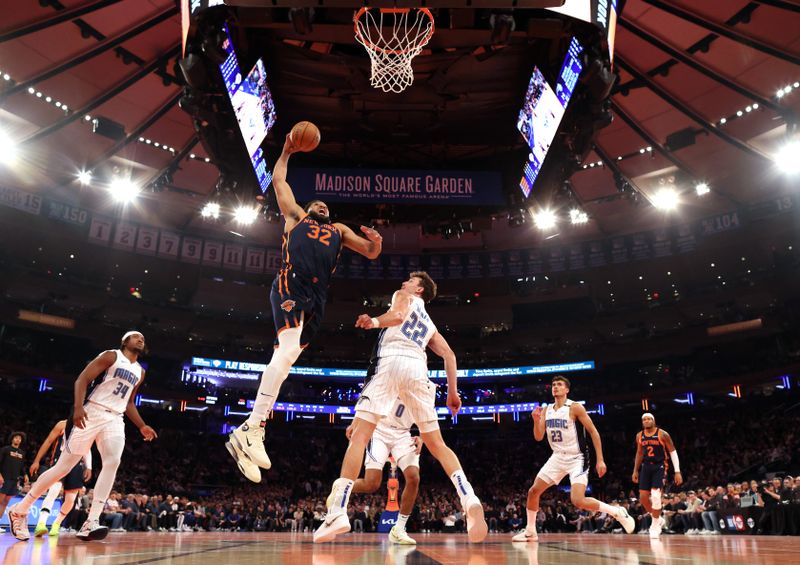 NEW YORK, NEW YORK - DECEMBER 03: Karl-Anthony Towns #32 of the New York Knicks dunks against Franz Wagner #22 of the Orlando Magic during their game at Madison Square Garden on December 03, 2024 in New York City.   User expressly acknowledges and agrees that, by downloading and or using this photograph, User is consenting to the terms and conditions of the Getty Images License Agreement.  (Photo by Al Bello/Getty Images)