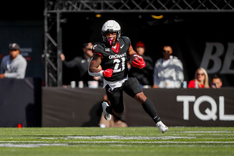 Oct 21, 2023; Cincinnati, Ohio, USA; Cincinnati Bearcats running back Corey Kiner (21) runs with the ball against the Baylor Bears in the first half at Nippert Stadium. Mandatory Credit: Katie Stratman-USA TODAY Sports