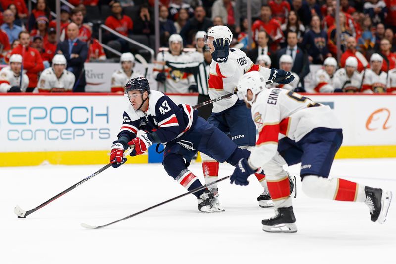 Nov 8, 2023; Washington, District of Columbia, USA; Washington Capitals right wing Tom Wilson (43) skates with the puck as Florida Panthers defenseman Gustav Forsling (42) and Panthers defenseman Oliver Ekman-Larsson (91) defend in the third period at Capital One Arena. Mandatory Credit: Geoff Burke-USA TODAY Sports