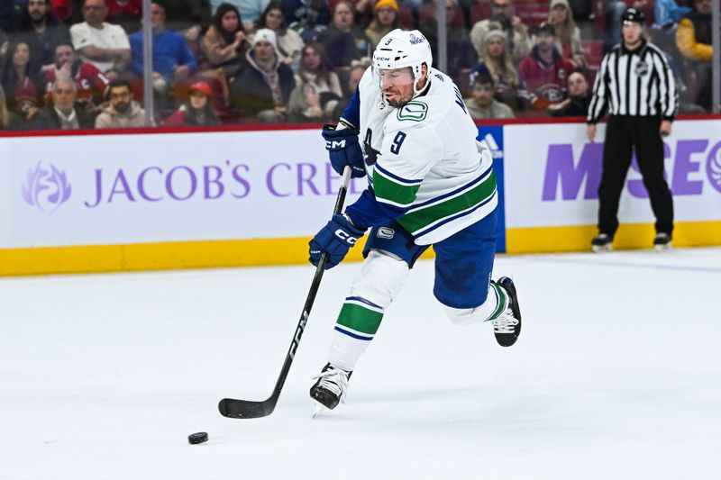 Nov 12, 2023; Montreal, Quebec, CAN; Vancouver Canucks center J.T. Miller (9) shoots the puck against the Montreal Canadiens during the first period at Bell Centre. Mandatory Credit: David Kirouac-USA TODAY Sports