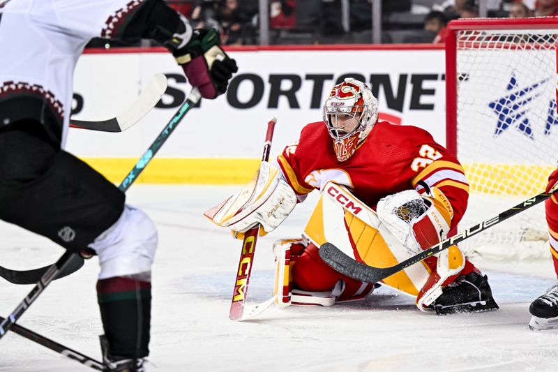 Apr 14, 2024; Calgary, Alberta, CAN; Calgary Flames goaltender Dustin Wolf (32) keeps his eye on the play against the Arizona Coyotes during the second period at Scotiabank Saddledome. Mandatory Credit: Brett Holmes-USA TODAY Sports