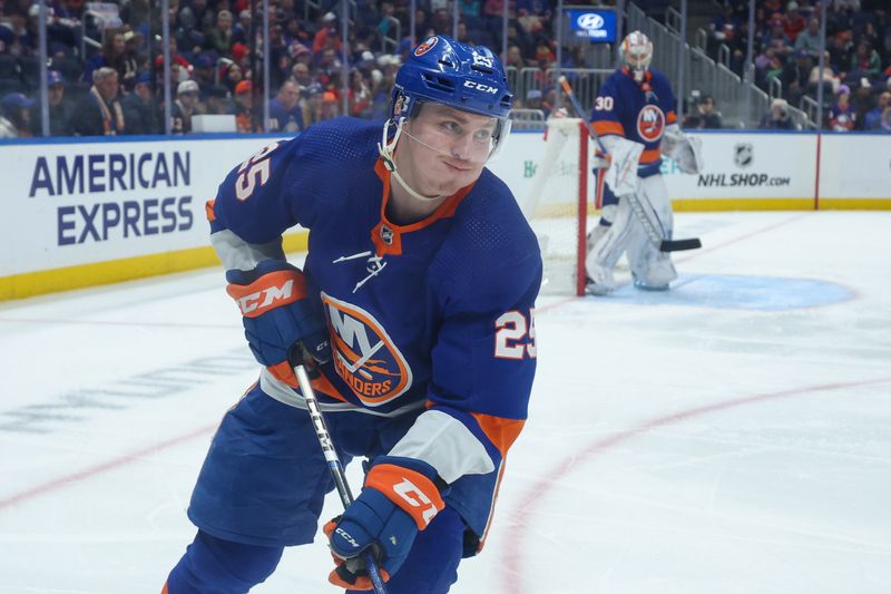 Apr 2, 2024; Elmont, New York, USA; New York Islanders defenseman Sebastian Aho (25) moves the puck against the Chicago Blackhawks during the third period at UBS Arena. Mandatory Credit: Thomas Salus-USA TODAY Sports