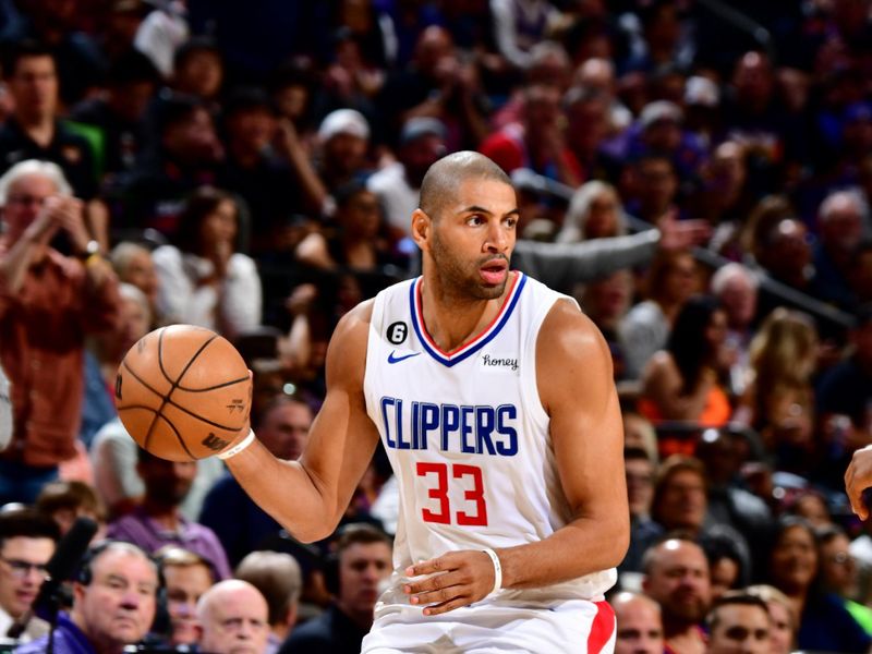 PHOENIX, AZ - APRIL 18: Nicolas Batum #33 of the LA Clippers dribbles the ball during the game against the Phoenix Suns during Round 1 Game 2 of the 2023 NBA Playoffs on April 18, 2023 at Footprint Center in Phoenix, Arizona. NOTE TO USER: User expressly acknowledges and agrees that, by downloading and or using this photograph, user is consenting to the terms and conditions of the Getty Images License Agreement. Mandatory Copyright Notice: Copyright 2023 NBAE (Photo by Barry Gossage/NBAE via Getty Images)