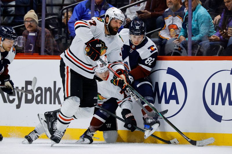 Oct 28, 2024; Denver, Colorado, USA; Chicago Blackhawks left wing Patrick Maroon (77) controls the puck ahead of Colorado Avalanche center Ivan Ivan (82) and left wing Lukas Reichel (73) in the third period at Ball Arena. Mandatory Credit: Isaiah J. Downing-Imagn Images