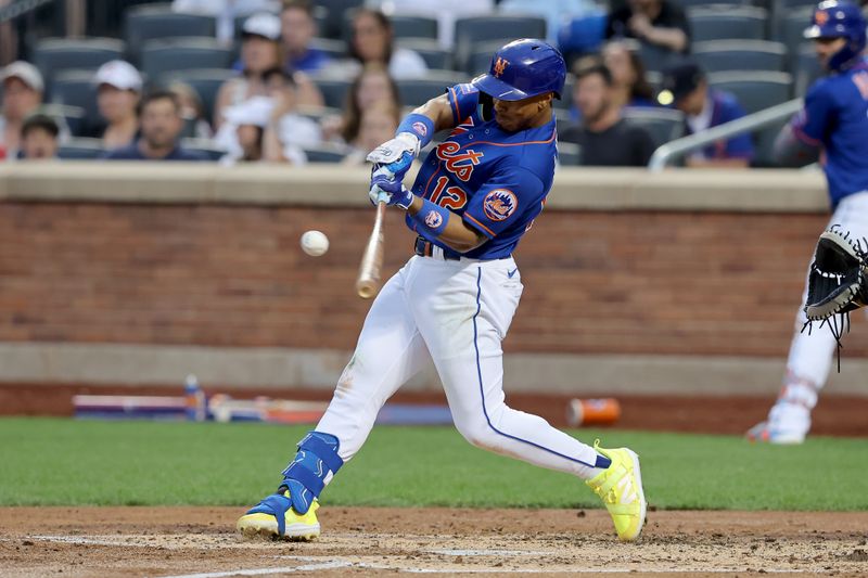 Jun 26, 2023; New York City, New York, USA; New York Mets shortstop Francisco Lindor (12) hits an RBI sacrifice fly against the Milwaukee Brewers during the fourth inning at Citi Field. Mandatory Credit: Brad Penner-USA TODAY Sports