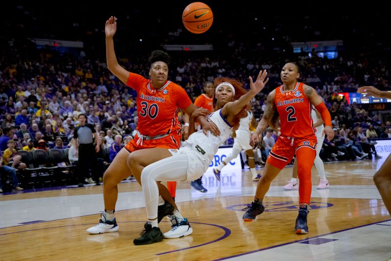 Feb 22, 2024; Baton Rouge, Louisiana, USA;  Auburn Tigers center Savannah Scott (30) knocks down LSU Lady Tigers forward Angel Reese (10) during the first half at Pete Maravich Assembly Center. Mandatory Credit: Matthew Hinton-USA TODAY Sports