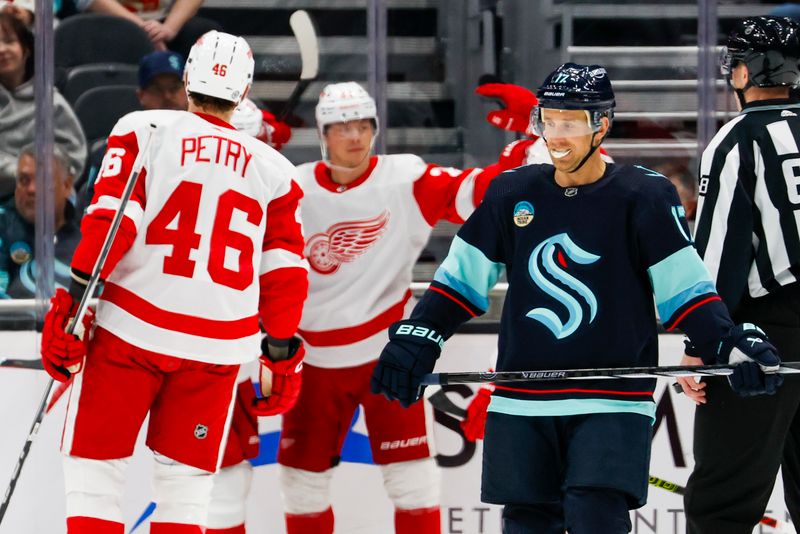 Feb 19, 2024; Seattle, Washington, USA; Seattle Kraken center Jaden Schwartz (17) reacts following a goal by Detroit Red Wings left wing Lucas Raymond (23, background) during the second period at Climate Pledge Arena. Mandatory Credit: Joe Nicholson-USA TODAY Sports