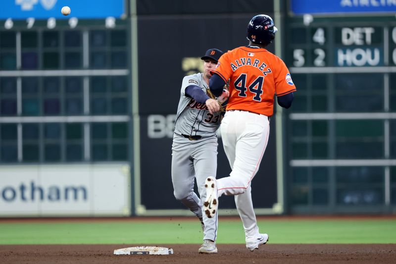 Oct 2, 2024; Houston, Texas, USA; Detroit Tigers second base Colt Keith (33) turns a double play against Houston Astros outfielder Yordan Alvarez (44) during the sixth inning of game two of the Wildcard round for the 2024 MLB Playoffs at Minute Maid Park. Mandatory Credit: Thomas Shea-Imagn Images