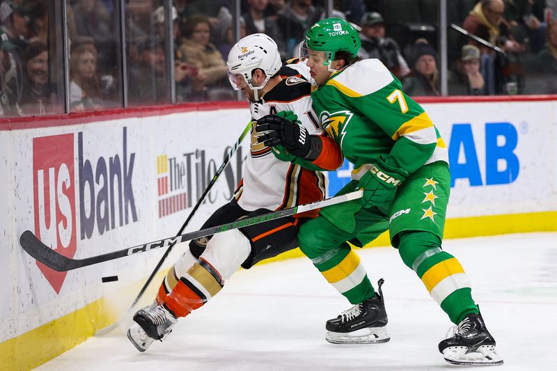 Jan 27, 2024; Saint Paul, Minnesota, USA; Anaheim Ducks center Adam Henrique (14) and Minnesota Wild defenseman Brock Faber (7) compete for the puck during the first period at Xcel Energy Center. Mandatory Credit: Matt Krohn-USA TODAY Sports