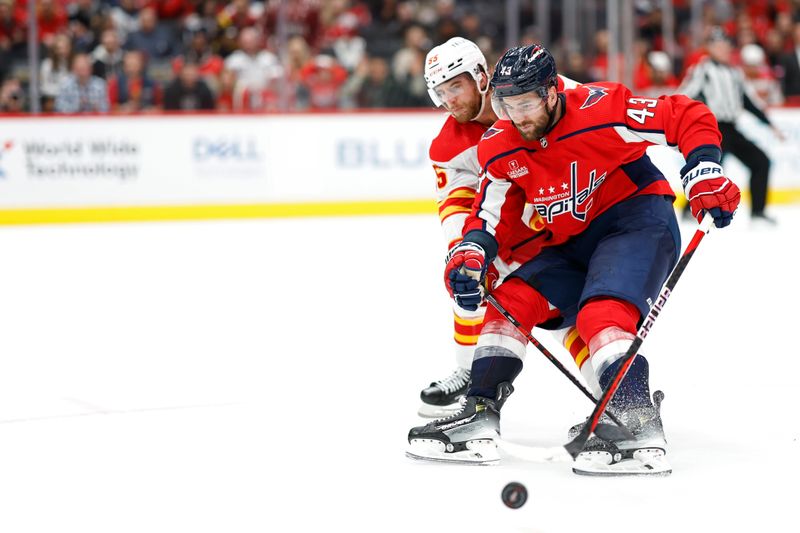 Oct 16, 2023; Washington, District of Columbia, USA; Washington Capitals right wing Tom Wilson (43) skates with the puck on goal as Calgary Flames defenseman Noah Hanifin (55) defends in the third period at Capital One Arena. Mandatory Credit: Geoff Burke-USA TODAY Sports