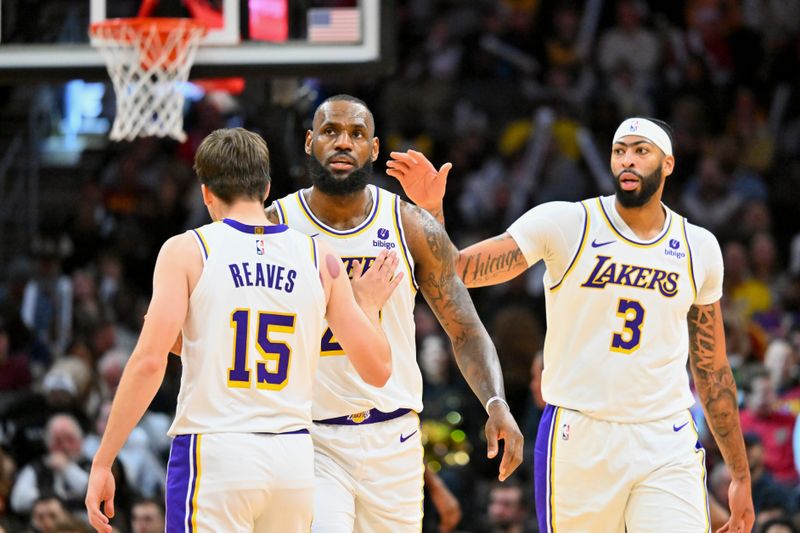 CLEVELAND, OHIO - NOVEMBER 25: Austin Reaves #15 and Anthony Davis #3 celebrate with LeBron James #23 of the Los Angeles Lakers during the third quarter against the Cleveland Cavaliers at Rocket Mortgage Fieldhouse on November 25, 2023 in Cleveland, Ohio. The Lakers defeated the Cavaliers 121-115. NOTE TO USER: User expressly acknowledges and agrees that, by downloading and or using this photograph, User is consenting to the terms and conditions of the Getty Images License Agreement. (Photo by Jason Miller/Getty Images)