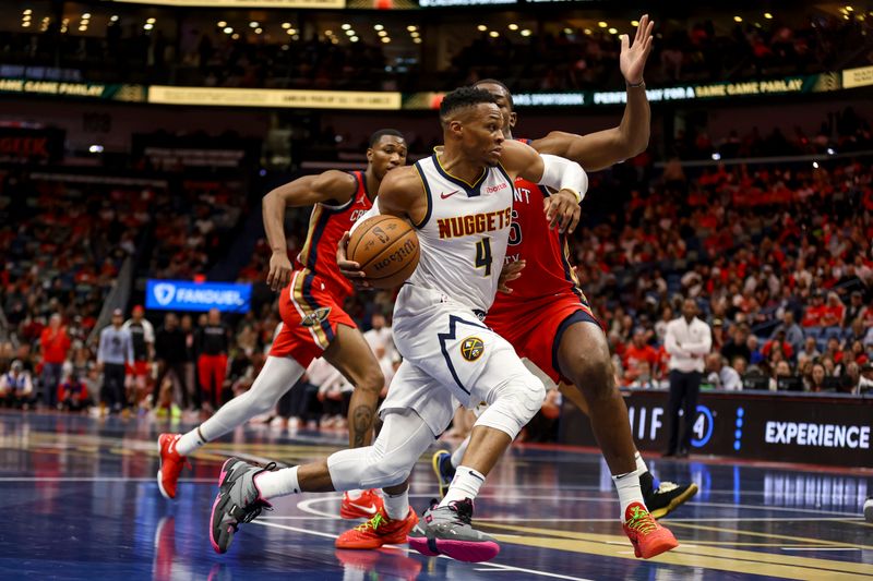 NEW ORLEANS, LOUISIANA - NOVEMBER 15:  Russell Westbrook #4 of the Denver Nuggets drives past Trey Jemison III #55 of the New Orleans Pelicans during the first half of an Emirates NBA Cup game at the Smoothie King Center on November 15, 2024 in New Orleans, Louisiana. NOTE TO USER: User expressly acknowledges and agrees that, by downloading and or using this photograph, User is consenting to the terms and conditions of the Getty Images License Agreement. (Photo by Derick E. Hingle/Getty Images)