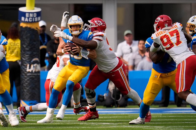 Los Angeles Chargers quarterback Justin Herbert, left, is sacked for a 6-yard loss by Kansas City Chiefs defensive tackle Chris Jones during the first half of an NFL football game Sunday, Sept. 29, 2024, in Inglewood, Calif. (AP Photo/Marcio Jose Sanchez)