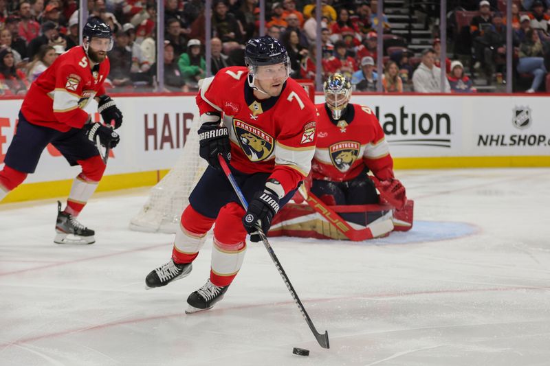 Feb 6, 2024; Sunrise, Florida, USA; Florida Panthers defenseman Dmitry Kulikov (7) moves the puck against the Philadelphia Flyers during the third period at Amerant Bank Arena. Mandatory Credit: Sam Navarro-USA TODAY Sports