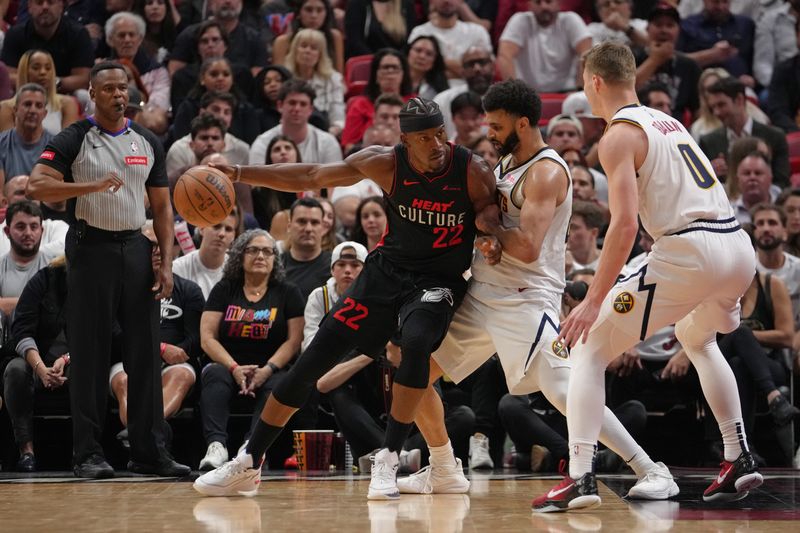 MIAMI, FL - MARCH 13: Jimmy Butler #22 of the Miami Heat dribbles the ball during the game against the Denver Nuggets on March 13, 2024 at Kaseya Center in Miami, Florida. NOTE TO USER: User expressly acknowledges and agrees that, by downloading and or using this Photograph, user is consenting to the terms and conditions of the Getty Images License Agreement. Mandatory Copyright Notice: Copyright 2024 NBAE (Photo by Eric Espada/NBAE via Getty Images)