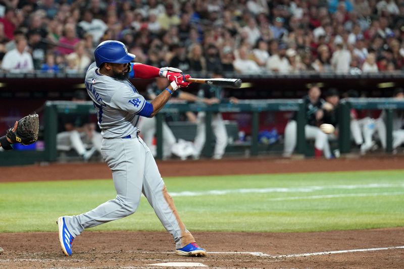 Sep 2, 2024; Phoenix, Arizona, USA; Los Angeles Dodgers outfielder Teoscar Hernández (37) hits a single against the Arizona Diamondbacks during the seventh inning at Chase Field. Mandatory Credit: Joe Camporeale-USA TODAY Sports